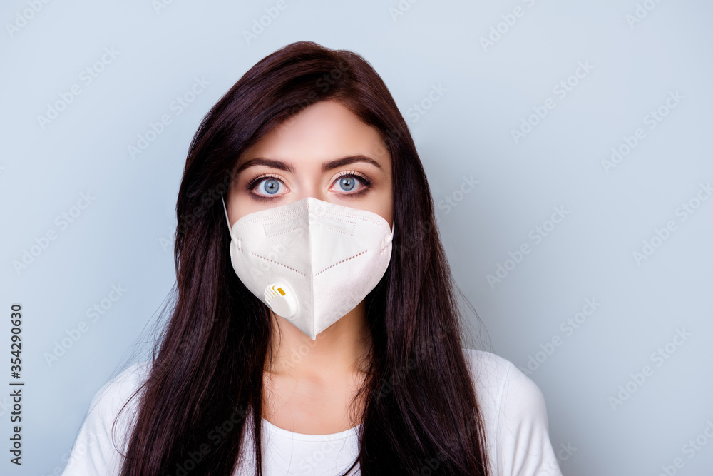 Close-up portrait of her she nice attractive worried serious brunette girl wearing medicine mask preventive measures stop disease sickness illness isolated over grey pastel color background Close-up portrait of her she nice attractive worried serious brunette girl wearing medicine mask preventive measures stop disease sickness illness isolated over grey pastel color background