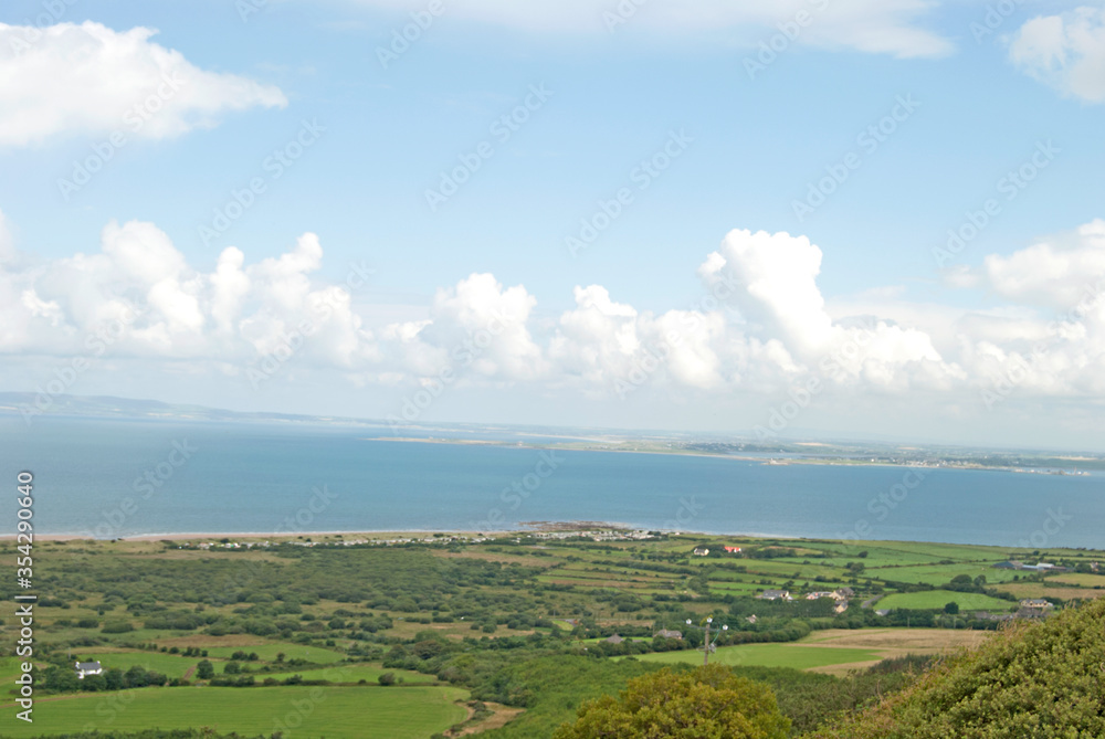 View from a hill on the green landscape with lots of fields, Ireland