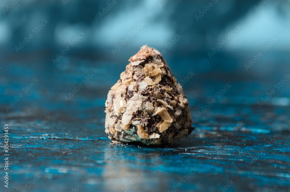 Chocolate candies in waffle chips close-up on blue background Chocolate candies in waffle chips close-up on blue background