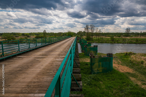 Obraz na płótnie Longest wooden bridge over the Pilica river in Gostomia, Poland w salonie
