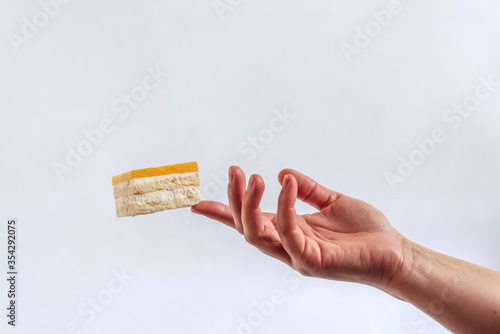 Composition of hands and cakes. Delicate hands and delicious cakes. Cakes floating in the air. Sorcery and magic, levitation