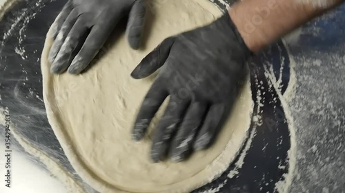 dynamic closeup of making pizza dough at italian restaurant