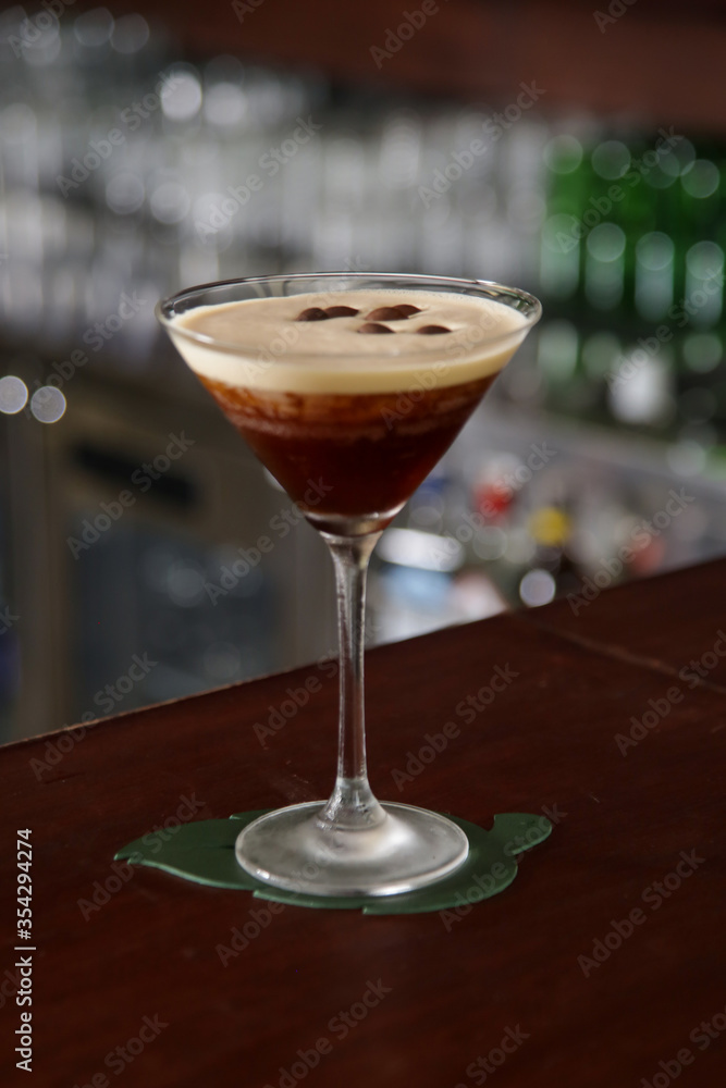 A glass of classic espresso martini on the bar counter