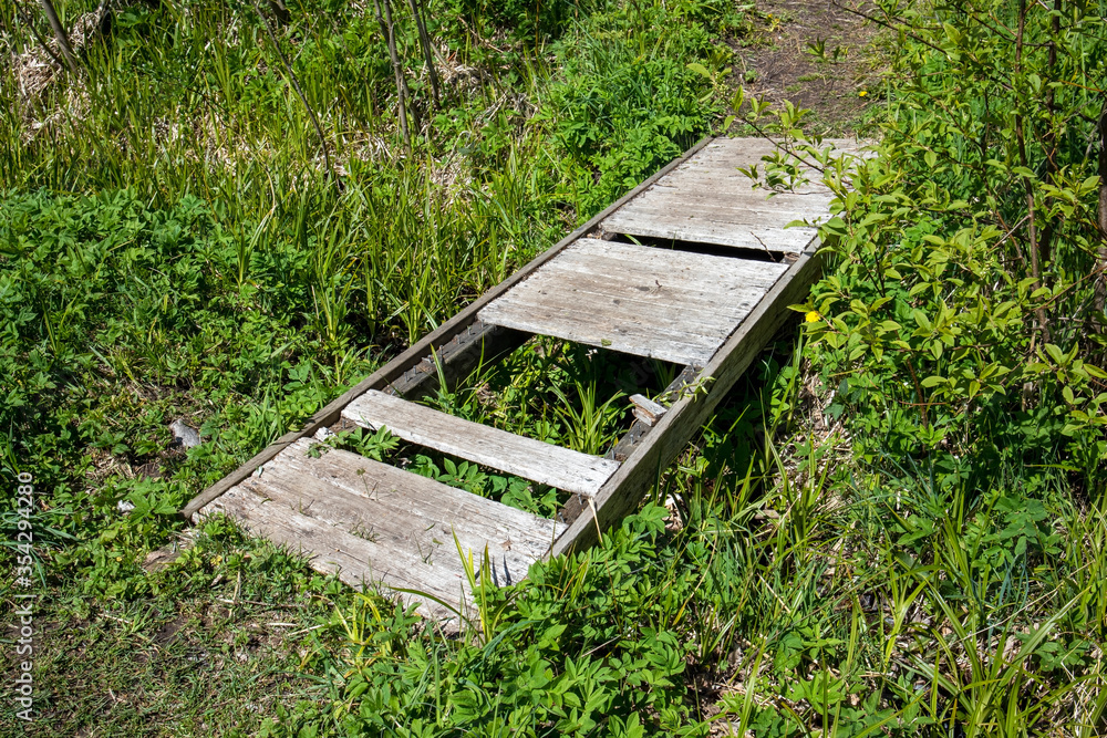 Fototapeta premium little wooden bridge with missing planks