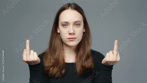 Video of young girl in black shirt showing fuck finger, close-up