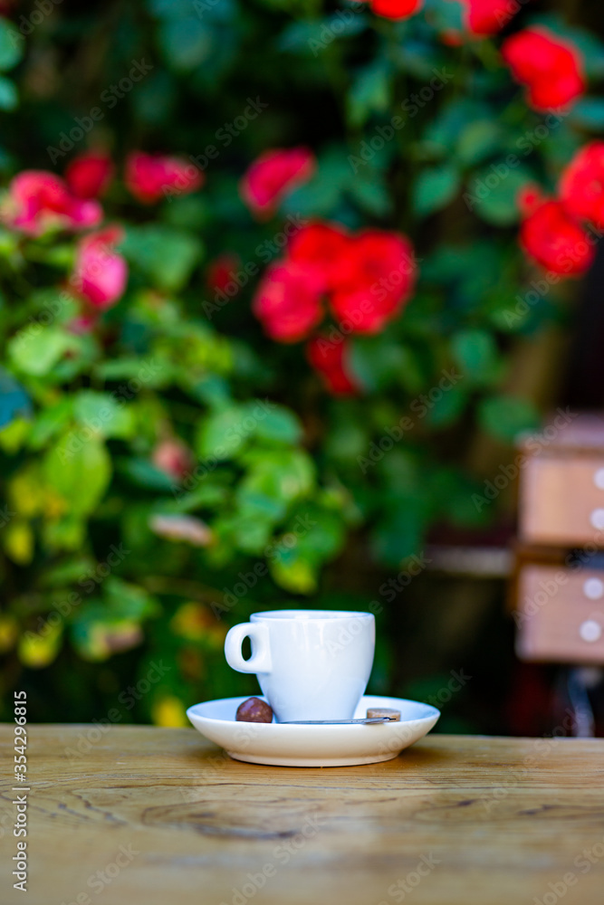 cup with coffee stands on a table on the background of a city cafe cup with coffee stands on a table on the background of a city cafe
