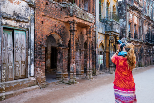 Bangladesh, Admiring tourist ruins of red ancient buildings in Sonargaon from the Medieval Mughal Period photo