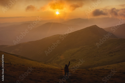 girl looking on the sunset in the mountains