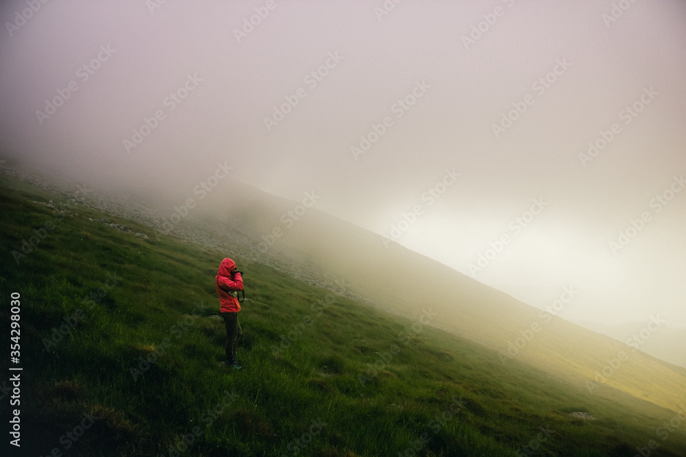 taking photo in foggy mountains