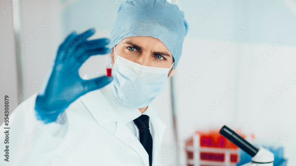 close up. ampoule with a vaccine in the hands of a scientist. close up. ampoule with a vaccine in the hands of a scientist.