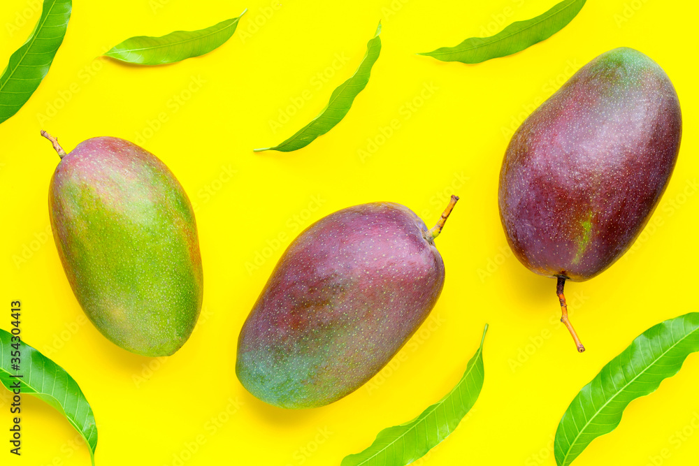 Mango, Tropical fruit with leaves on yellow background. Mango, Tropical fruit with leaves on yellow background.