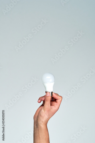Lightbulb in hand. Eco business. Ecology concept.