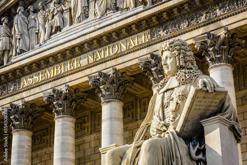 Fotótapéta Close-up of the statue of Francois d'Aguesseau and the inscription Assemblée Nationale in golden letters on the pediment of the Palais Bourbon, seat of the french National Assembly in Paris