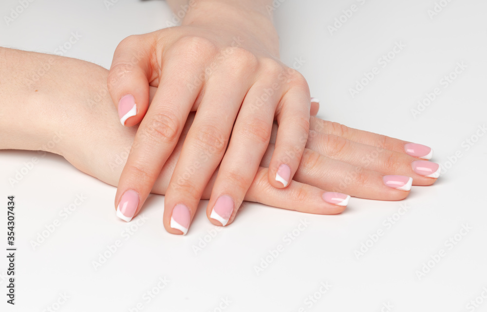 Well-groomed female hands with manicure on white background Well-groomed female hands with manicure on white background