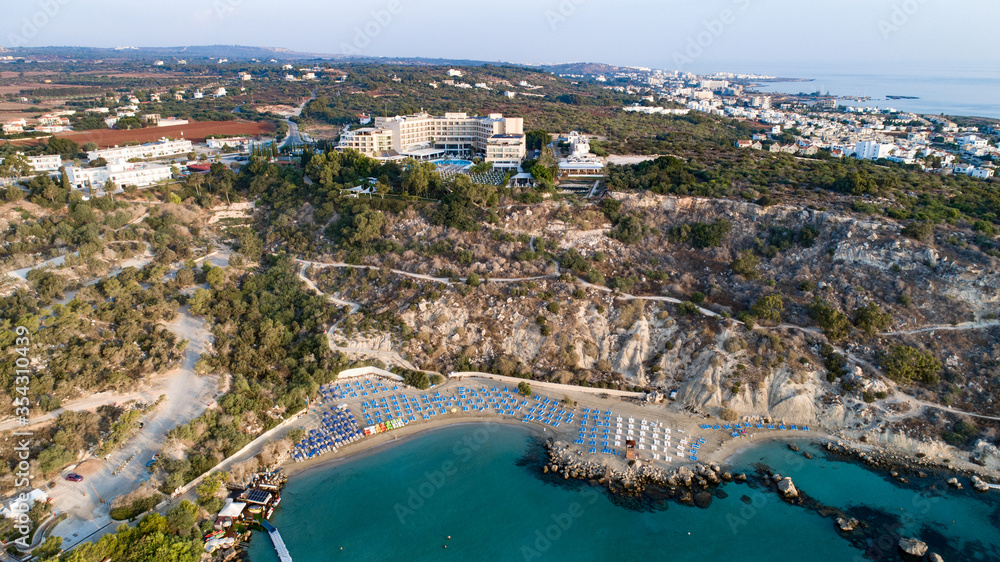Aerial bird's eye view of Konnos beach in Cavo Greco Protaras, Paralimni, Famagusta, Cyprus. The famous tourist attraction golden sandy Konos bay, yachts, on summer holidays, at sunrise from above