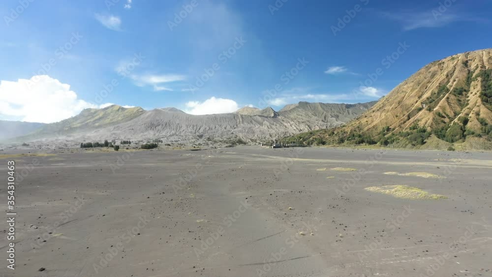 View from above, stunning aerial view of the Mount Batok and the Mount Bromo illuminated during a sunny day. Mount Bromo is an active volcano in East Java, Indonesia.
View from above, stunning aerial view of the Mount Batok and the Mount Bromo illuminated during a sunny day. Mount Bromo is an active volcano in East Java, Indonesia.