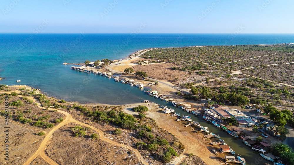 Aerial bird's eye view Liopetri river to sea (potamos Liopetriou), Famagusta, Cyprus.Fjord landmark tourist attraction fishing village with colourful boats moored on banks at Kokkinochoria, from above