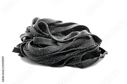Black fresh tagliatelle pasta with squid ink on a white isolated background