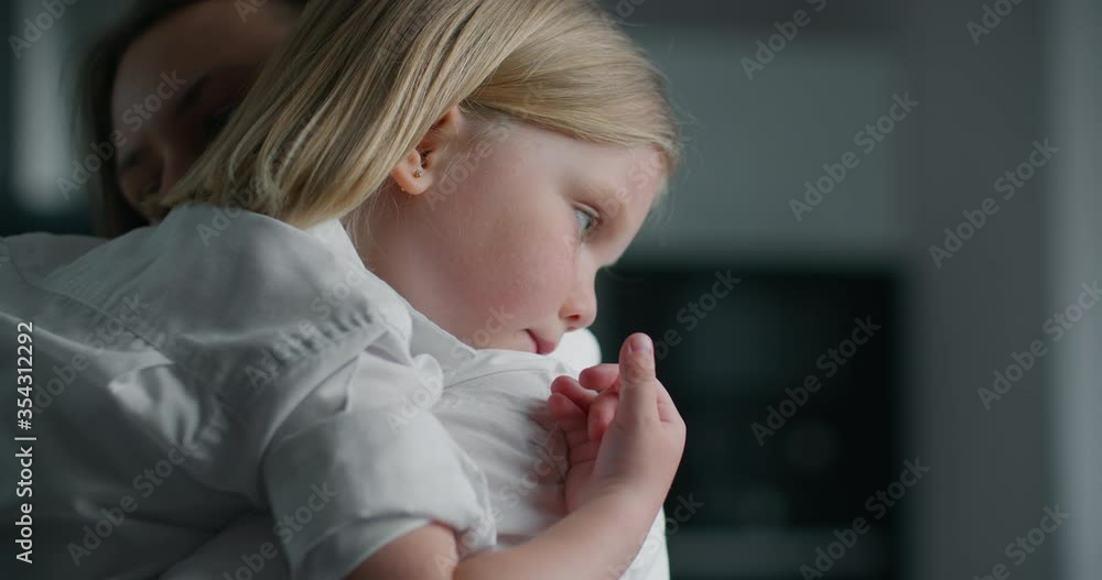 Mother holds little daughter in her arms and reassures her. Female Porter Close-up. Mother holds little daughter in her arms and reassures her. Female Porter Close-up.