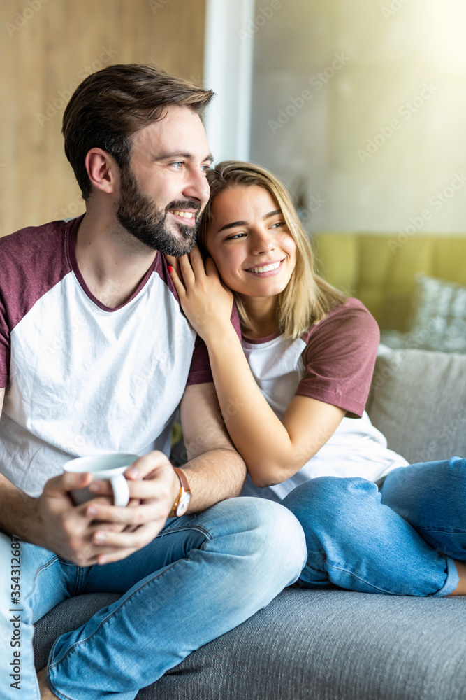 Portrait of a young couple drinking coffee in their living room Portrait of a young couple drinking coffee in their living room