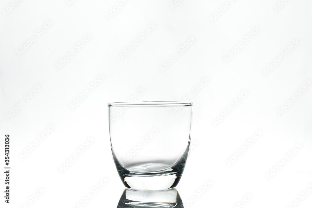 Empty glass on white background. Isolated. Backlight. Empty glass on white background. Isolated. Backlight.