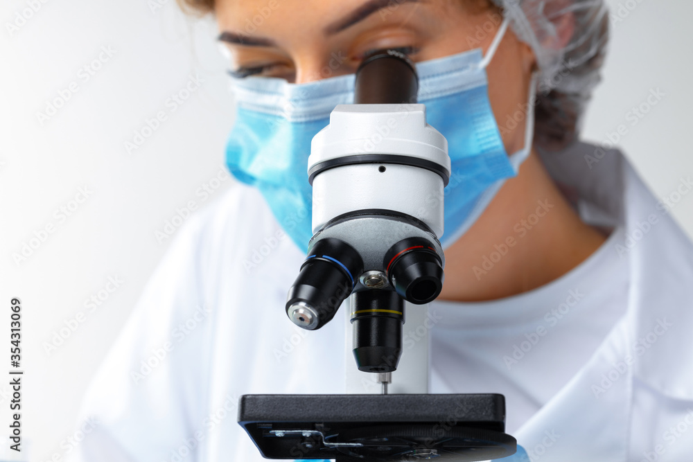 Close up photo of woman scientist working with microscope