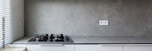 Stylish kitchen with gray countertop, panorama