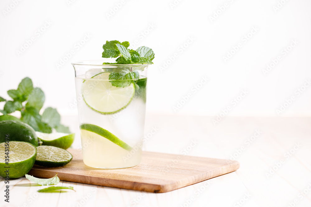 Lemonade or mojito cocktail with fresh lime and mint leaves Lemonade or mojito cocktail with fresh lime and mint leaves