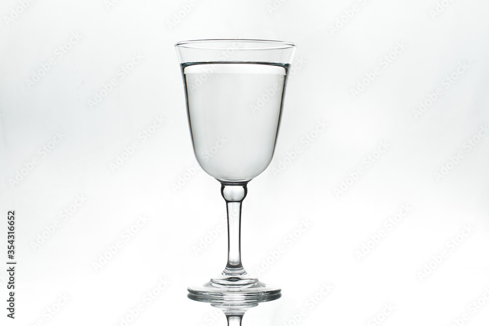 Full glass on white background. Isolated. Backlight. Full glass on white background. Isolated. Backlight.