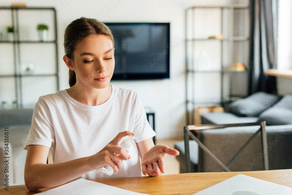 attractive woman using hand sanitizer at home attractive woman using hand sanitizer at home