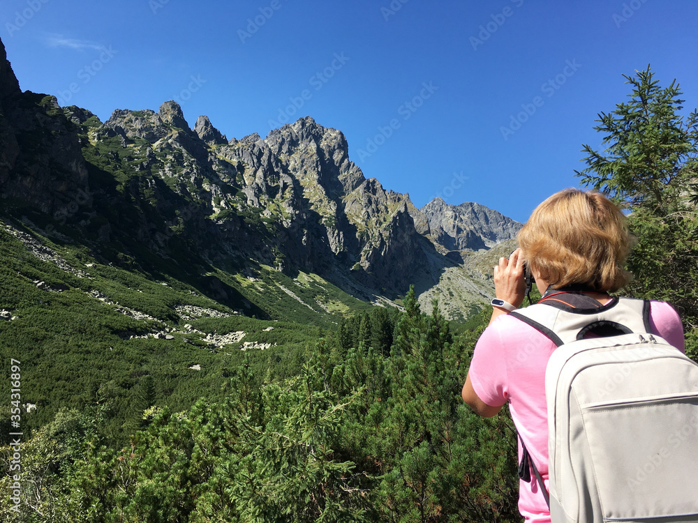 Woman hiker shoots beautiful landscape in High Tatras.