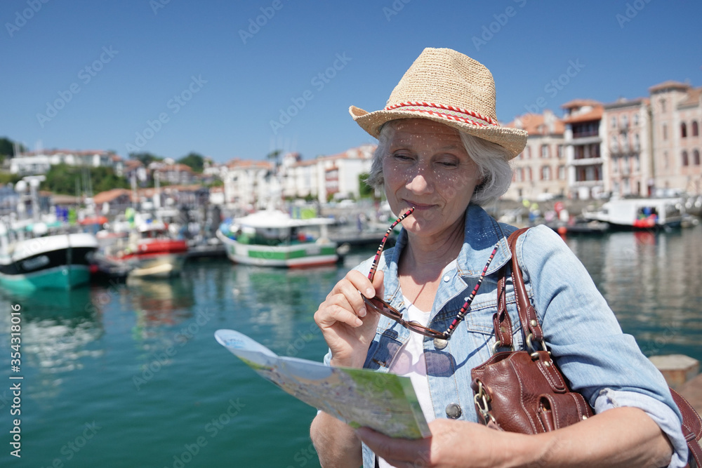 Portrait of senior woman visiting touristic town