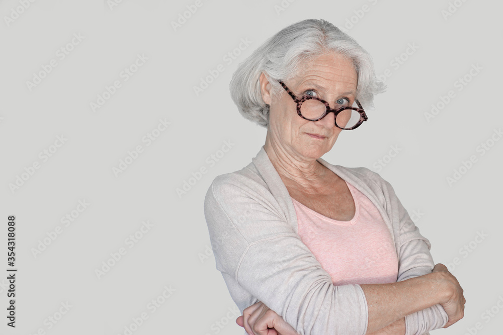 Portrait of senior woman with red eyeglasses, isolated Portrait of senior woman with red eyeglasses, isolated