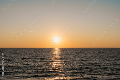 Sea at sunset with beautiful reflections  gradient sky on horizon. Touristic destination.