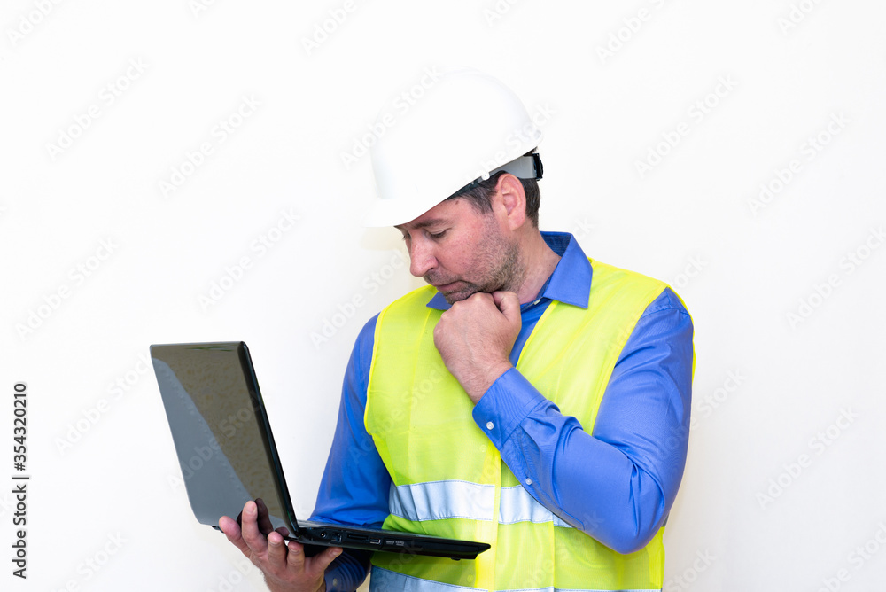Attractive caucasian Technician Holding Laptop Over White Background.Makes all kinds of grimaces-eyes closed, upset, thinking, shows thumb up, and ok gesture...