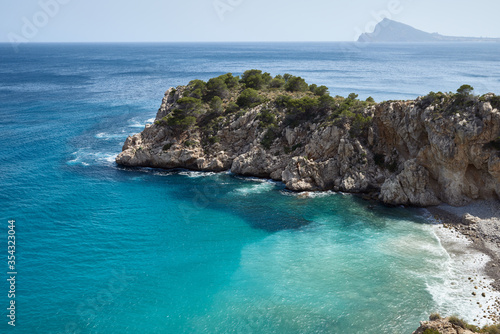Inlet with turquoise and crystal clear water in Denia, Spain. Concept of vacation and leisure. Long shot.