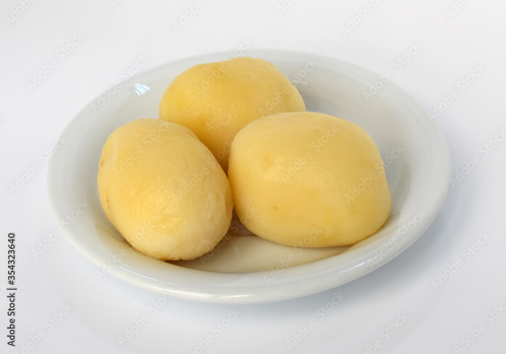 Boiled peeled potatoes on white