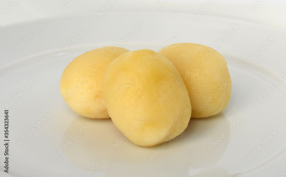Boiled peeled potatoes on white