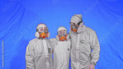 The family shield protect, to save life from virus. Slow motion. People portrait, wearing protect medical aerosol spray paint mask respirator. Concept health safety protection coronavirus epidemic. photo