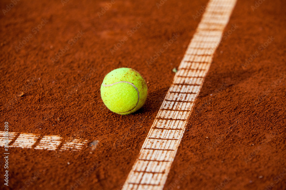 Tennis ball on the clay court.