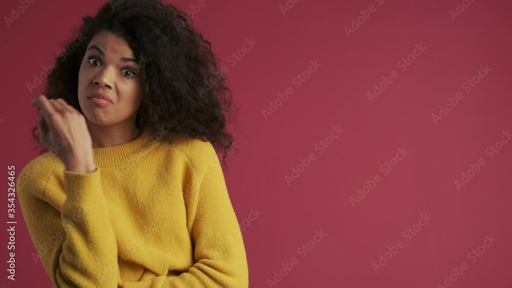 Young african surprised woman isolated over dark red burgundy background looking aside Young african surprised woman isolated over dark red burgundy background looking aside