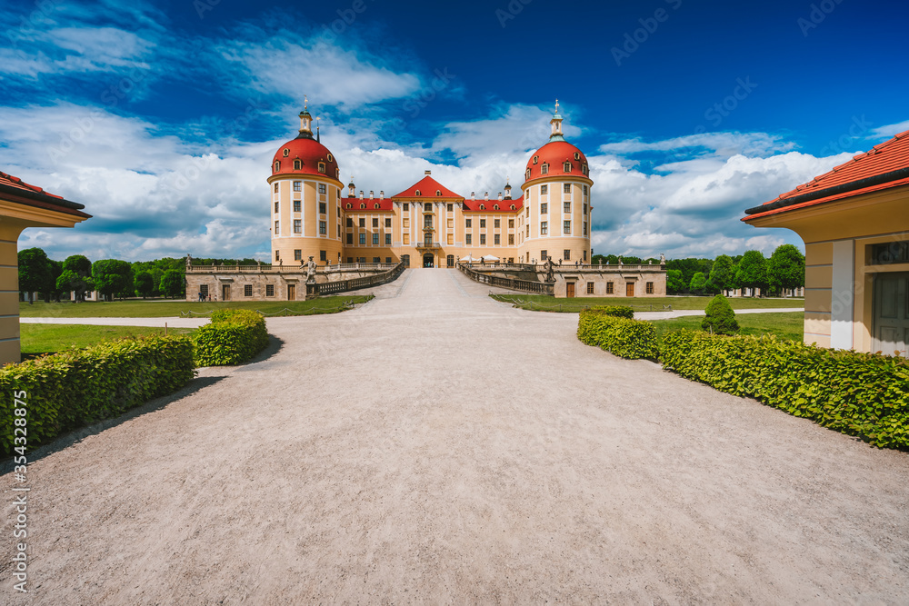 Germany, Saxony region, Dresden, Castle Moritzburg. Beautiful spring day with blue sky and white clouds. Walking path lead to castle and park