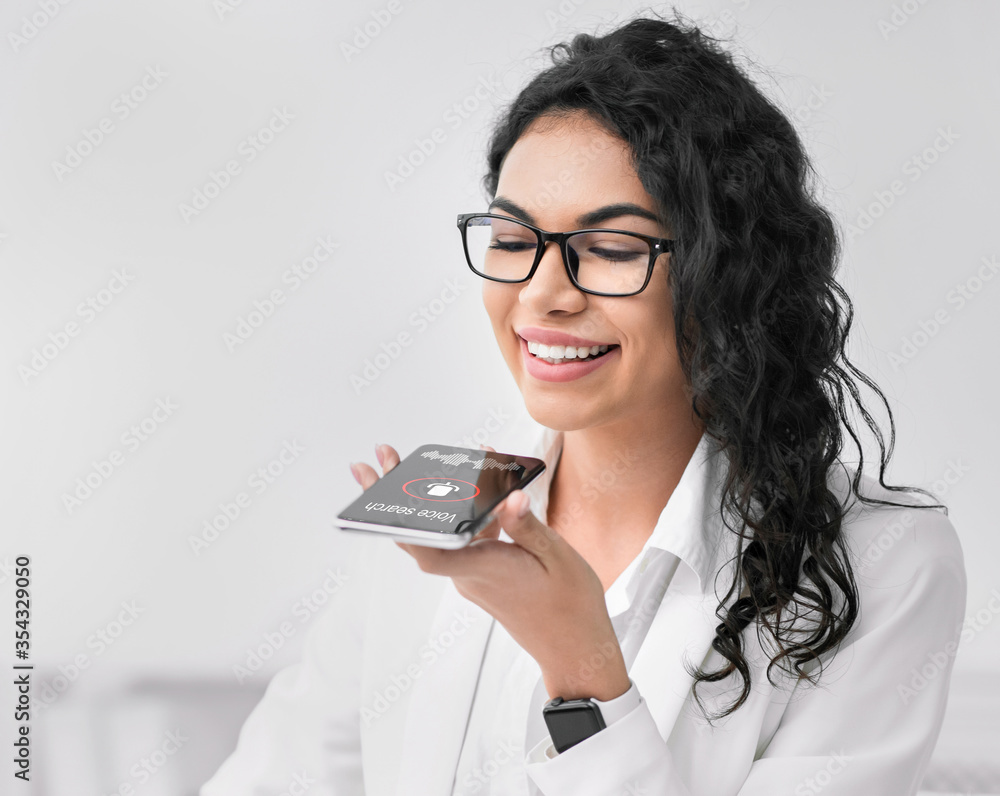 Mexican Businesswoman Using Smartphone Voice Search App At Workplace Indoor Mexican Businesswoman Using Smartphone Voice Search App At Workplace Indoor