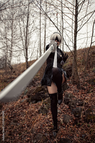 beautiful woman in black dress beats with sword, cosplay