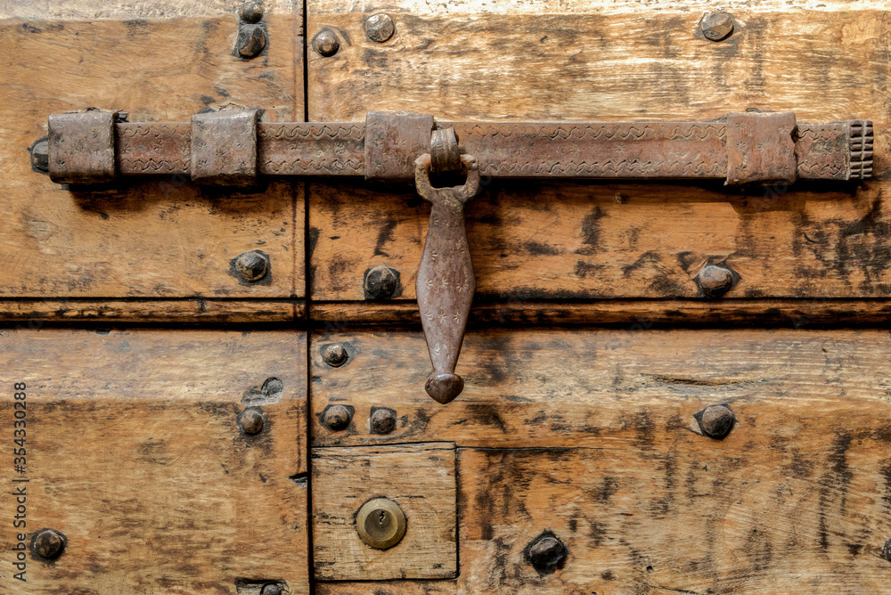 Ancient wooden door in a medieval Italian village / the XVI century