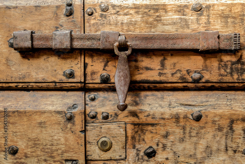 Ancient wooden door in a medieval Italian village / the XVI century