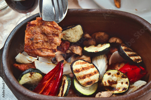 Traditional Serbian dish known as rostilj includes grilled pork neck and chicken breast, pljeskavica, cevapi and beef steak served with grilled vegetables photo
