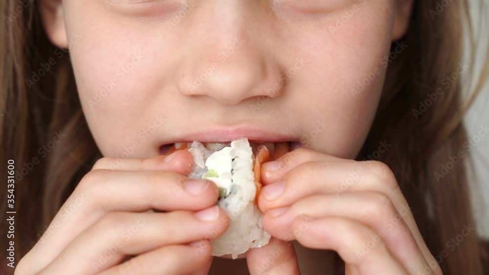 close-up. girl eating roll home. delivery of Oriental food and home products. close-up. girl eating roll home. delivery of Oriental food and home products.