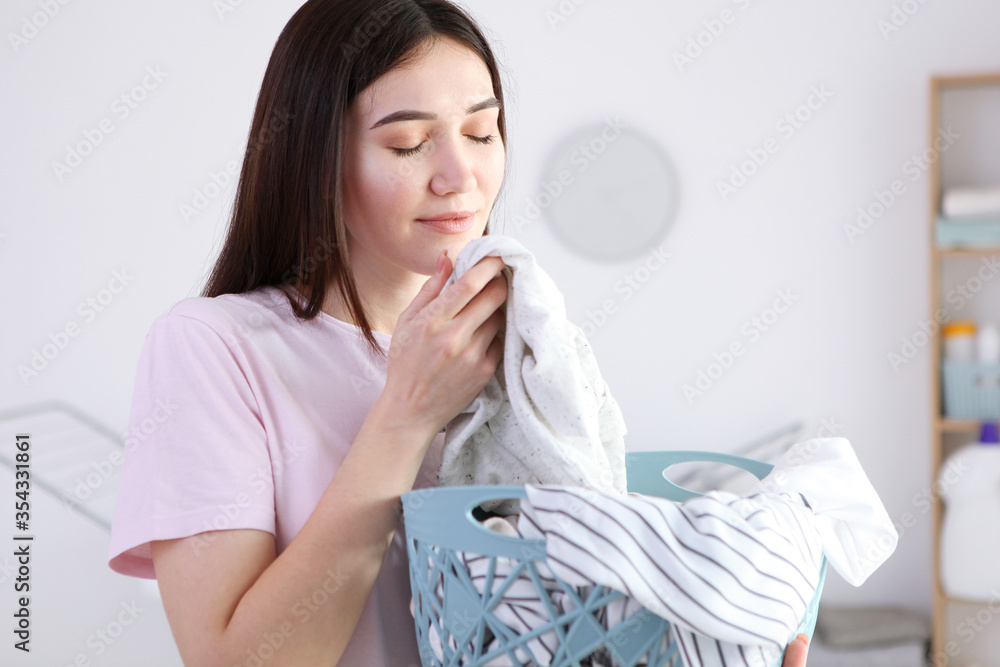 Young housewife in the laundry room. Laundry, household chores
Young housewife in the laundry room. Laundry, household chores