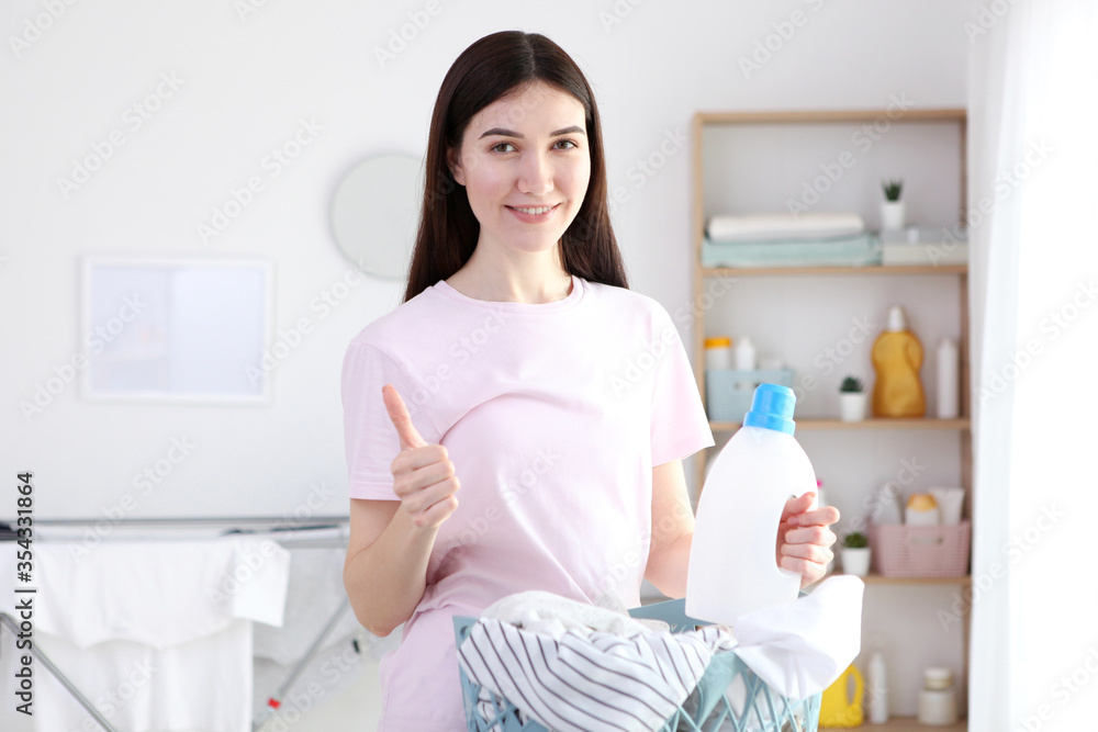Young housewife in the laundry room. Laundry, household chores
Young housewife in the laundry room. Laundry, household chores